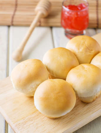 butter bread with strawberry jam on wood table
