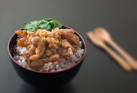 stir fried pork garlic with rice on black bowlの写真素材