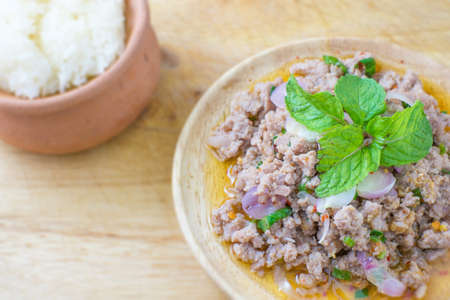 Spicy minced pork salad and sticky riceの写真素材