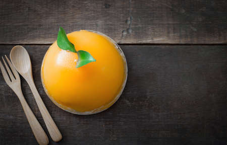 orange cake on rustic wood tableの写真素材