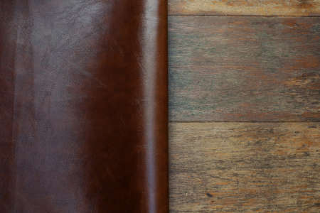 brown leather and rustic wood backgroundの写真素材
