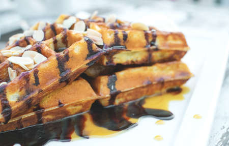 closeup chocolate waffle on top with almondの写真素材