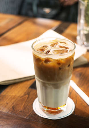Ice caramel espresso coffee on rustic wood table, vintage toneの写真素材