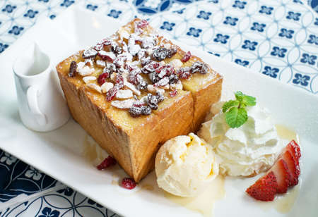 Honey toast with strawberry and vanilla icecream on white dishの写真素材