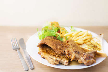 pork and chicken steak with salad and french friedの写真素材