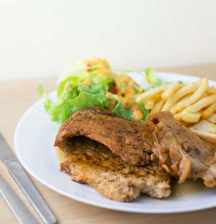 pork and chicken steak with salad and french friedの写真素材