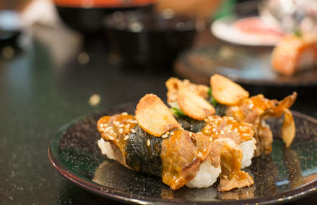 beef sushi on black dishの写真素材
