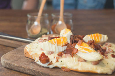 bacon pizza ontop with boiled eggの写真素材