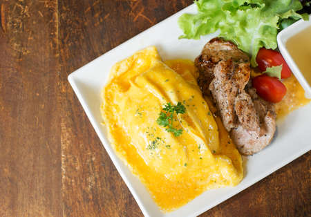 omelete rice with roasted pork on wood tableの写真素材