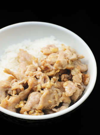 pepper pork rice with black backgroundの写真素材