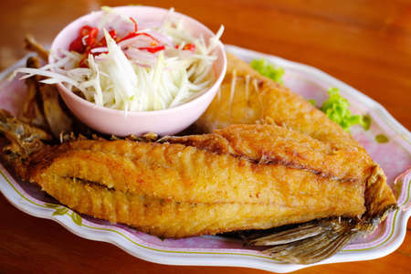 Deep fried fish with fish sauceの写真素材