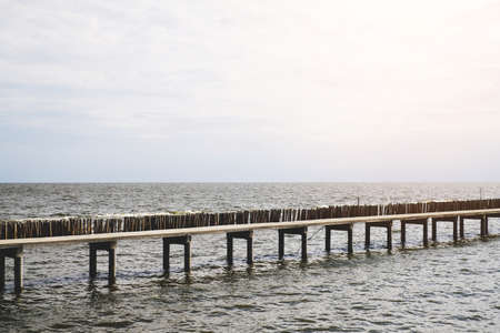 Long bridge beside water pier