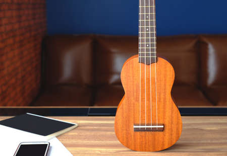 Retro guitar on wooden desk with blurry office backgroundの写真素材