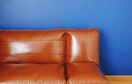 brown leather sofa with blue backgroundの写真素材