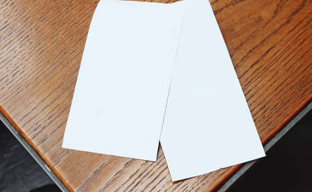 two white paper put on wooden tableの写真素材