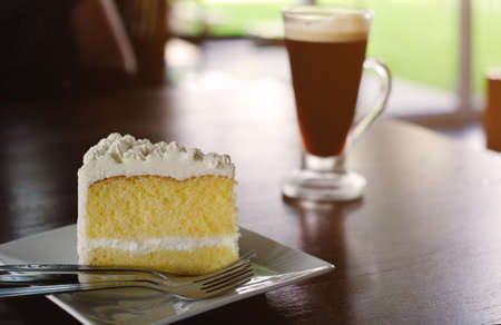 coconut cake with iced coffee background on wood tableの写真素材