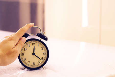 man hand push stop bell clock at morning