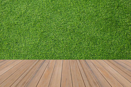 wooden board empty on grass field backgroundの写真素材