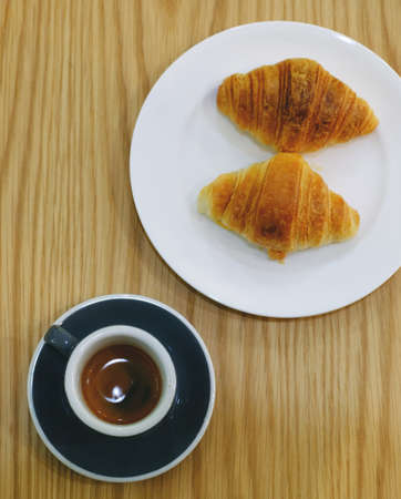 Top view of hot espresso and croissantの写真素材