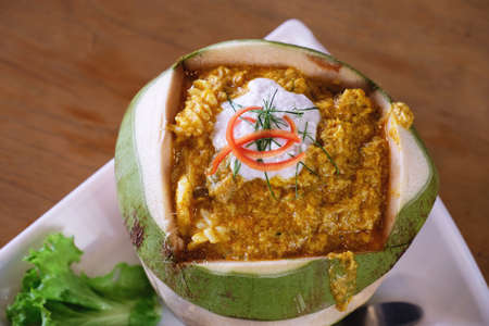 top view of Thai steamed seafood curry in coconutの写真素材