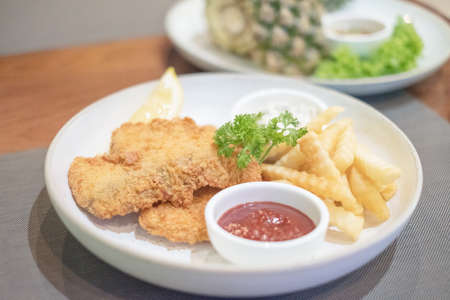 fish and chip on white dishの写真素材