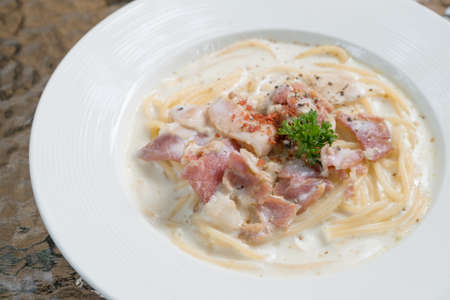 spaghetti carbonara with hamの写真素材