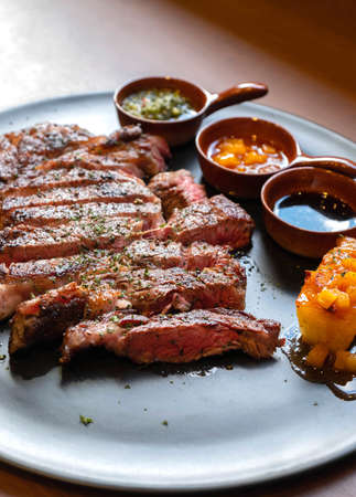 closeup medium rare ribeye steak on wood tableの写真素材