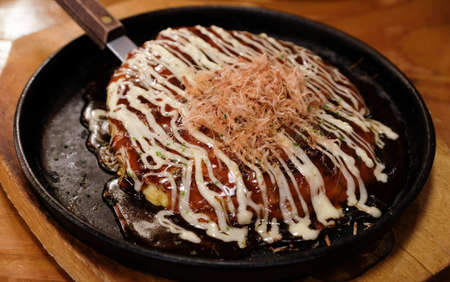 delicious okonomiyaki on wood tableの写真素材