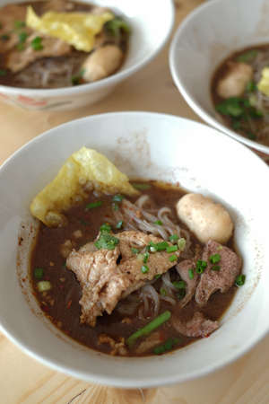 pork noodle thai style on wood tableの写真素材