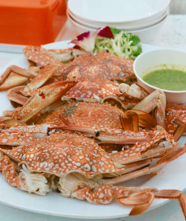 steam crab with spicy sauce on white tableの写真素材