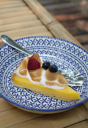 closeup lemon cheese tart on design dish