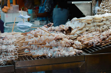 grilled squid, street food in thailandの写真素材