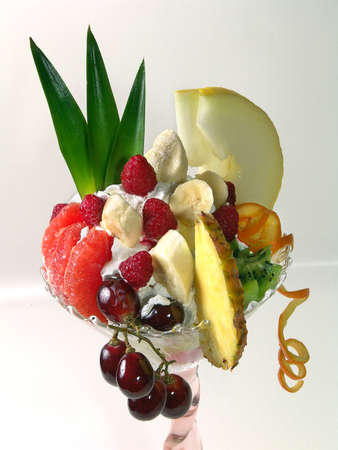 Exotic fruits in a glass with ice cream.