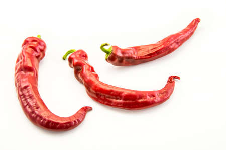 Red hot chili peppers on a white background.の写真素材