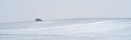 Field and hills covered with snow.