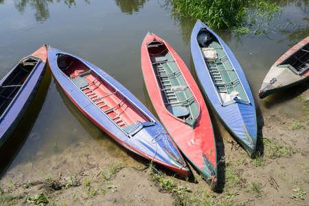 Kayaks without people parked by the river.の写真素材