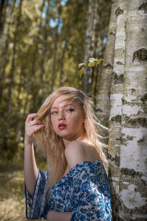 Lutsk. Ukraine. August 25, 2019; Beautiful blonde girl in a birch forest. Selective focus. Soft focus. Blurred background.のeditorial素材