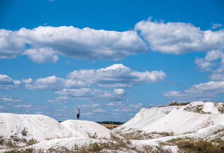 Sumy. Ukraine. August 6, 2019; Baby on a hill of white chalk quarryの写真素材