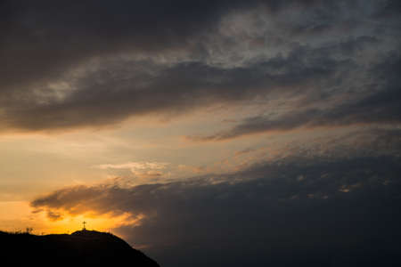 Christian cross. Silhouette against the sunset sky.の写真素材