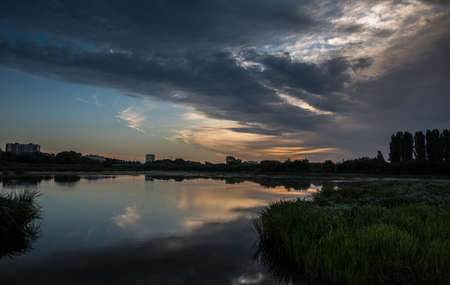 Beautiful sunset over the lake with colorful clouds.の写真素材