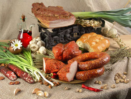 Still life of meat and sausages with spices and herbs.の写真素材