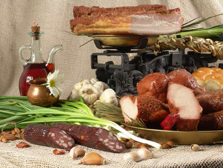 Still life of meat and sausages with spices and herbs.の写真素材