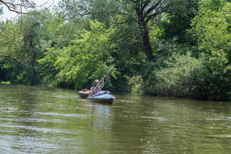 River Goryn. Ukraine. June 10, 2020; A group of tourists swim on the river in multi-colored kayaks.のeditorial素材