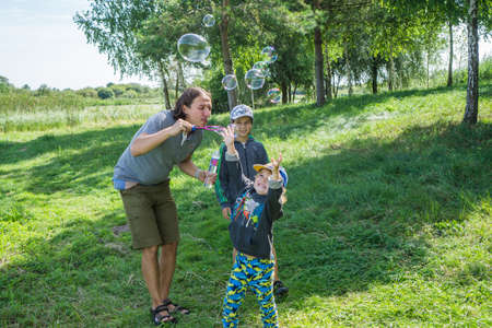 Ukraine. Lutsk. August 15, 2020; Father blows bubbles for his childrenのeditorial素材