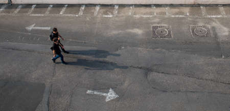 Odessa, Ukraine. September 3, 2017; Two people walk in the direction of the arrow.