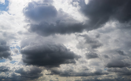 Dark cumulus clouds against a blue sky.