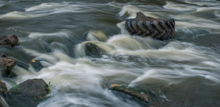 Blur the movement of water among the stones. Stingray in the river. Long exposure photography.の写真素材
