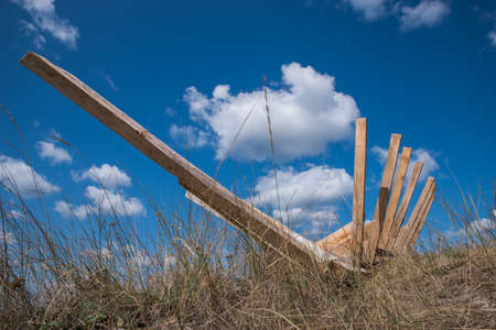 The ribs of a boat under construction against a blue cloudy sky.の写真素材