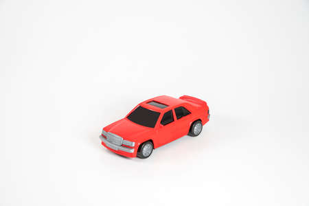 Toy plastic car isolated on white background. Red car.
