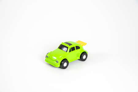 Toy plastic car isolated on white background. Light green car.